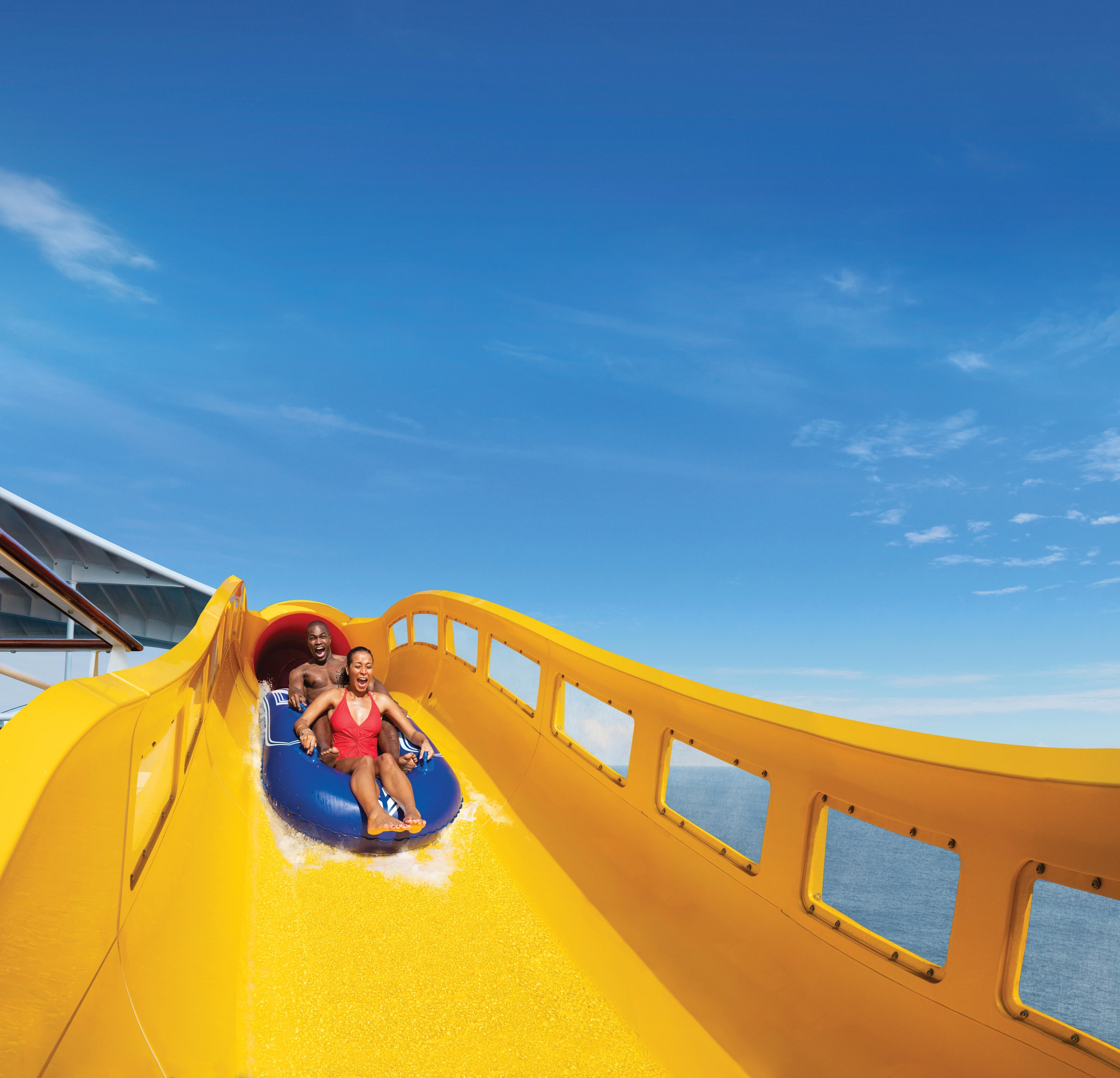 Couple going down water slide