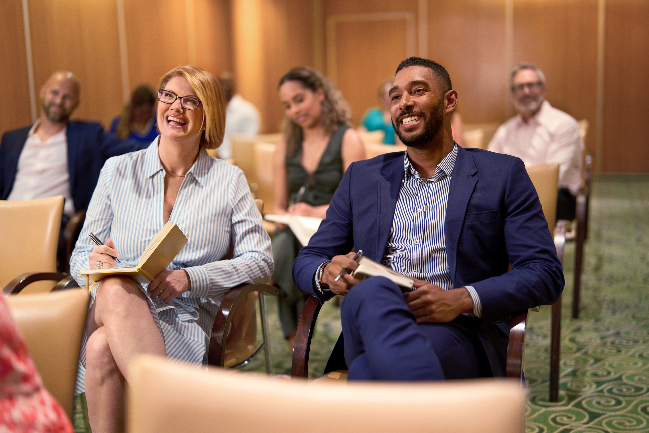 Attendees laughing during meeting on Royal Caribbean