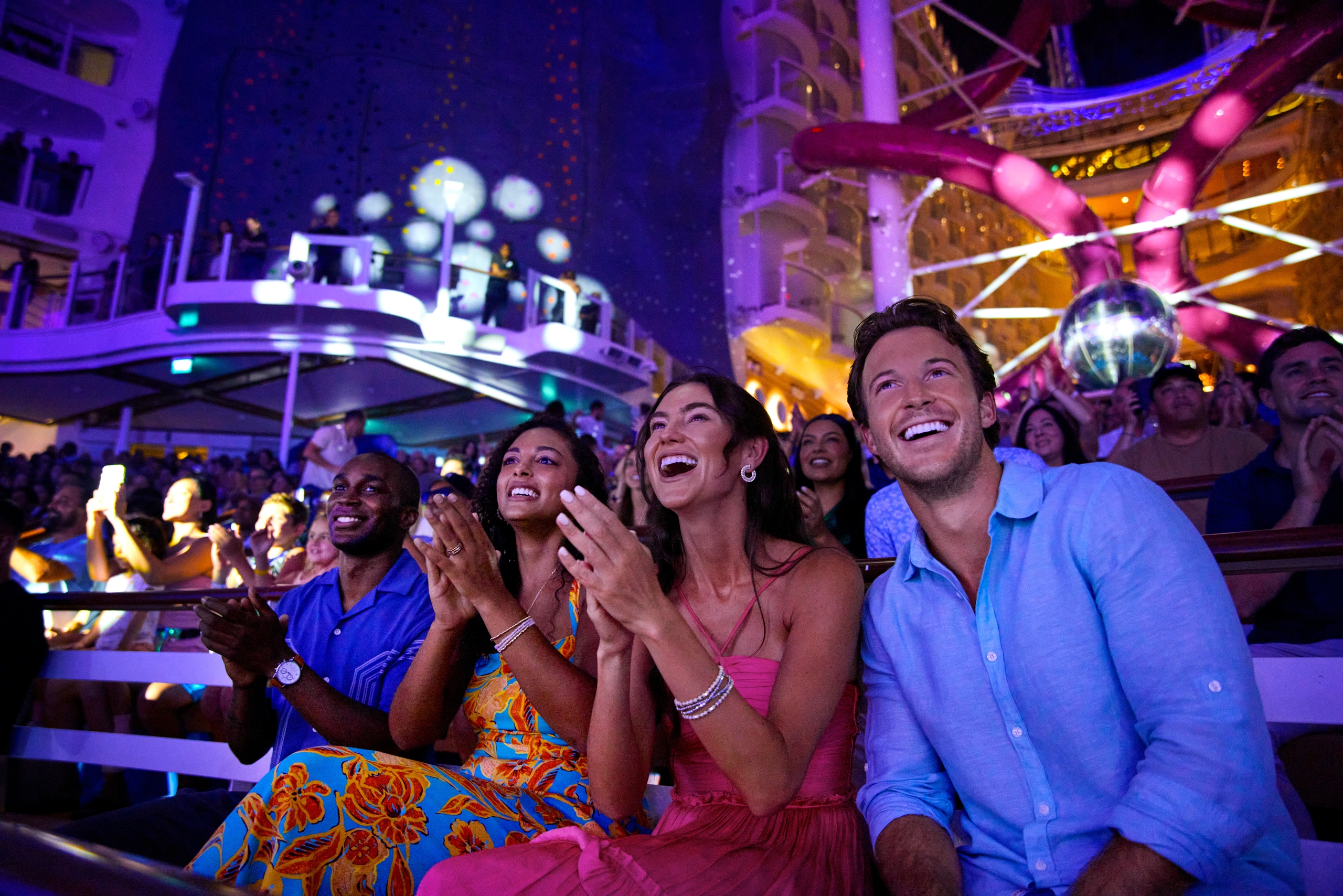 Two couple watchin show in Aqua Theater Royal Caribbean