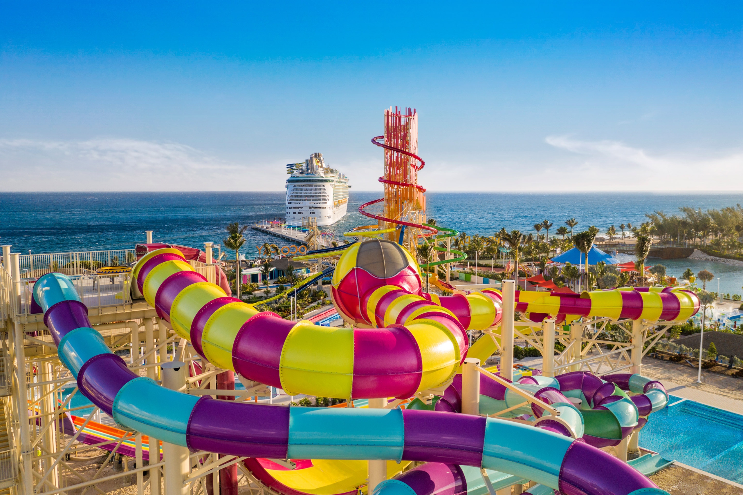 Perfect Day Coco Cay Slide Aerial with Navigator of the Seas in Background