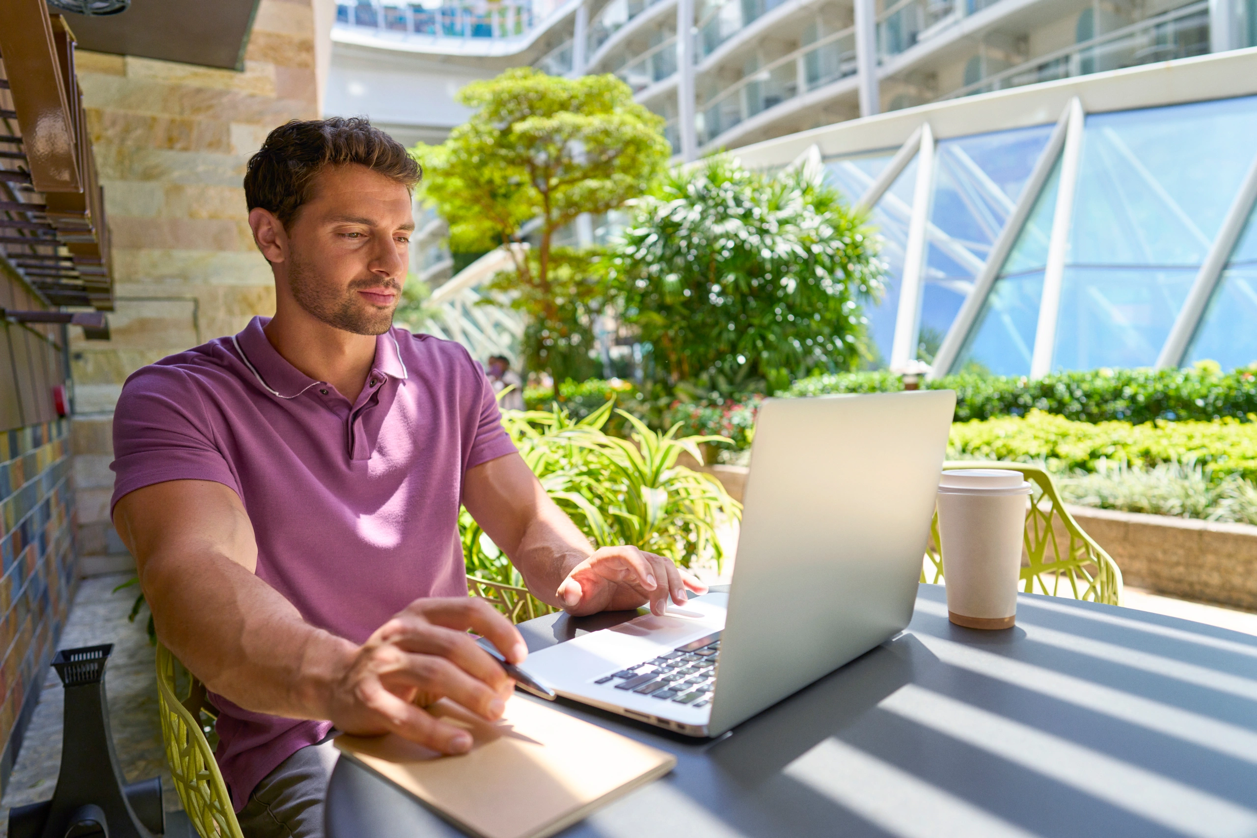 Man on computer with coffee